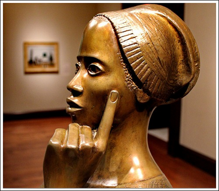 Title: Sculpture of a thoughtful woman by Elizabeth Catlett